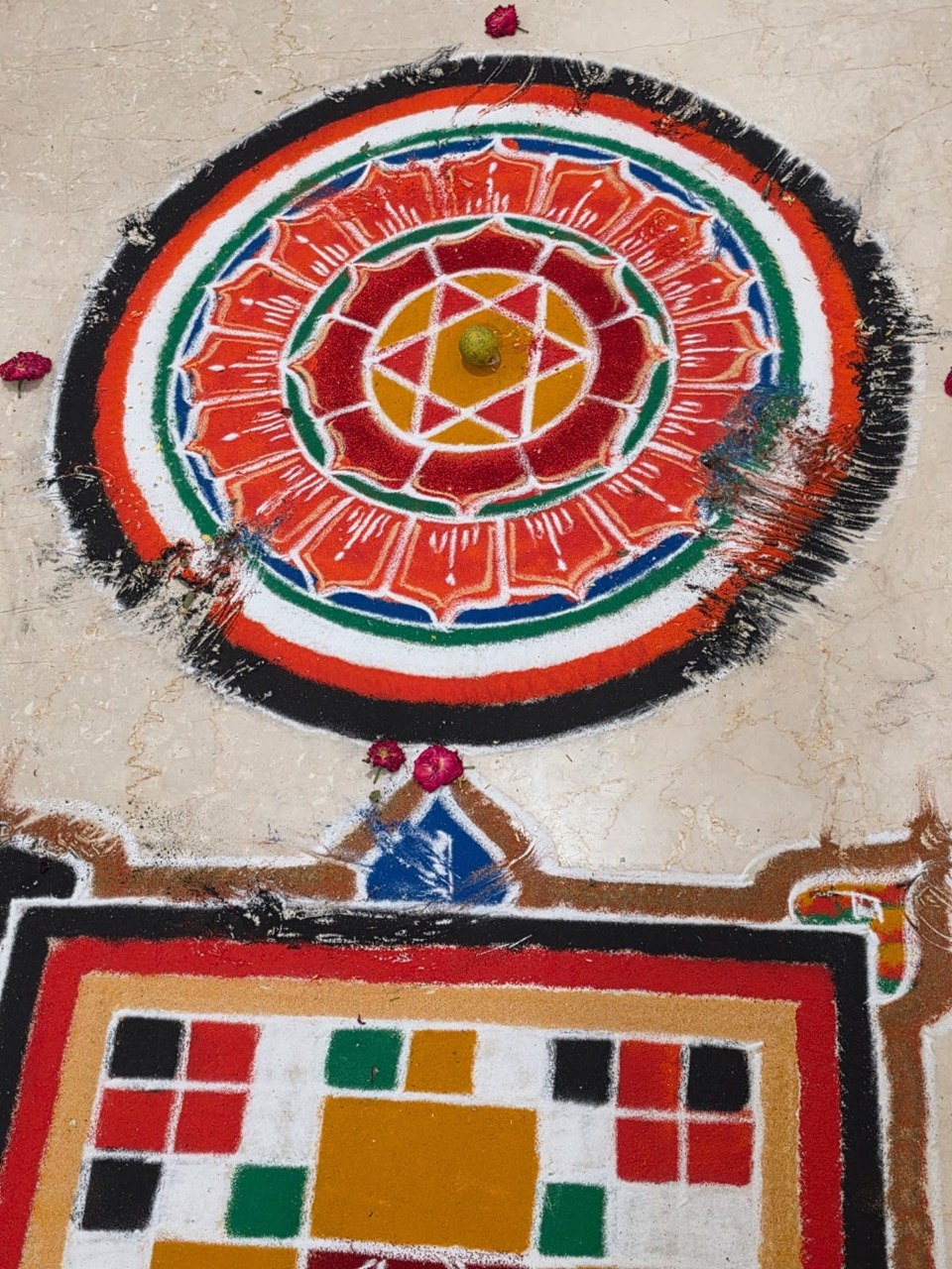A vastu yantra drawn in coloured powder on the floor